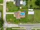 Aerial view showing private pool, large yard, and screen enclosure, set among other residential homes at 40449 Trotter Ln, Dade City, FL 33525