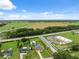 Expansive view of home featuring a pool, large manicured lot, and proximity to commercial property at 40449 Trotter Ln, Dade City, FL 33525