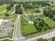 Overhead view showcasing property with green lawn, adjacent to a road and surrounded by neighborhood houses at 40449 Trotter Ln, Dade City, FL 33525