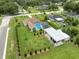 Aerial view of a single Gathering house with a private pool, carport, and well-manicured lawn at 40449 Trotter Ln, Dade City, FL 33525