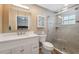 This bathroom is complete with a glass door shower, updated vanity with sink, and large mirror with medicine cabinet at 40449 Trotter Ln, Dade City, FL 33525