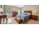 Comfortable bedroom with warm lighting and an ensuite bathroom offers a private retreat at 40449 Trotter Ln, Dade City, FL 33525