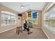 Bright exercise room with an exercise bike, large windows, and banners of local sports teams at 40449 Trotter Ln, Dade City, FL 33525