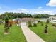 Charming single Gathering home features a well manicured lawn and attached two car garage at 40449 Trotter Ln, Dade City, FL 33525