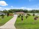 Charming single Gathering home features a well manicured lawn and attached two car garage at 40449 Trotter Ln, Dade City, FL 33525