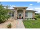 Inviting front entrance with a decorative brick archway and manicured landscaping at 40449 Trotter Ln, Dade City, FL 33525
