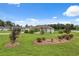 Landscaped front yard with flowering bushes and a well-maintained lawn, enhancing curb appeal at 40449 Trotter Ln, Dade City, FL 33525