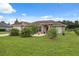 Charming single-story home with a well-manicured lawn and mature landscaping under a bright, sunny sky at 40449 Trotter Ln, Dade City, FL 33525