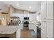 Bright, updated kitchen with stainless steel appliances, white cabinetry, and granite countertops and eat-in bar at 40449 Trotter Ln, Dade City, FL 33525