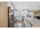 Updated kitchen featuring white cabinets, stainless steel appliances, and granite counters with bar seating at 40449 Trotter Ln, Dade City, FL 33525