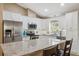 Modern kitchen with white cabinetry, stainless steel appliances, granite countertops and breakfast bar seating at 40449 Trotter Ln, Dade City, FL 33525
