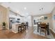 Open concept kitchen features white cabinetry, stainless steel appliances, granite countertops and breakfast bar at 40449 Trotter Ln, Dade City, FL 33525