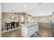 Spacious kitchen with white island that provides seating, and views of the dining area and living room at 40449 Trotter Ln, Dade City, FL 33525
