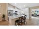 Updated kitchen with white cabinets, granite counters, stainless appliances and an island with bar stool seating at 40449 Trotter Ln, Dade City, FL 33525