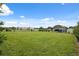 Large green lot featuring mature landscaping, carport, and proximity to commercial area at 40449 Trotter Ln, Dade City, FL 33525