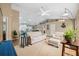 Bright living room boasts vaulted ceilings, neutral tones, and access to the kitchen for easy entertaining at 40449 Trotter Ln, Dade City, FL 33525