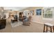 This great living room features access to the dining room, large bright windows, and cozy seating at 40449 Trotter Ln, Dade City, FL 33525