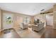 Bright living room with a large window, tile floors, and neutral-toned furniture at 40449 Trotter Ln, Dade City, FL 33525