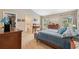 This main bedroom features neutral walls, a closet, an ensuite bath, and a large bed dressed in blues at 40449 Trotter Ln, Dade City, FL 33525
