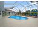 Inviting in-ground pool area with a screened enclosure, patio seating, and a well-maintained pool at 40449 Trotter Ln, Dade City, FL 33525