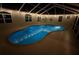Night view of a stunning in-ground pool within a screened enclosure with subtle lighting at 40449 Trotter Ln, Dade City, FL 33525