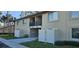 Exterior of two-story condo units featuring a neutral stucco and private patio at 4215 E Bay Dr # 1506C, Clearwater, FL 33764