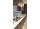 Close up on updated kitchen with stainless steel sink and mosaic tile backsplash at 4215 E Bay Dr # 1506C, Clearwater, FL 33764