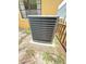 Exterior shot of the home's AC unit on a concrete slab, surrounded by greenery at 4306 Woodside Manor Dr, Tampa, FL 33624