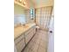 Bathroom featuring a single sink vanity with a toilet and tiled floor at 4306 Woodside Manor Dr, Tampa, FL 33624