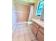 Bright bathroom with a tile shower, light-colored vanity, and tiled floors at 4306 Woodside Manor Dr, Tampa, FL 33624