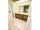 Bathroom with a vanity, a large mirror, a toilet, and a tiled floor at 4306 Woodside Manor Dr, Tampa, FL 33624
