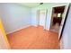 Bedroom with hardwood flooring, closet, and neutral paint at 4306 Woodside Manor Dr, Tampa, FL 33624
