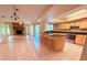 Open-concept kitchen featuring stainless steel appliances and a bar-style island with seating at 4306 Woodside Manor Dr, Tampa, FL 33624
