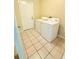 Functional laundry room featuring a side-by-side washer and dryer at 4306 Woodside Manor Dr, Tampa, FL 33624