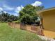 Well-maintained yard with green grass, accented by a charming picket fence at 4306 Woodside Manor Dr, Tampa, FL 33624