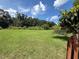 Large grassy yard with mature trees and a classic picket fence bordering the property at 4306 Woodside Manor Dr, Tampa, FL 33624