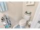 Cozy half bathroom with a toilet, storage rack, and modern decor at 4703 Somerset Hill Ln, Riverview, FL 33578