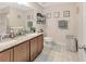 Bright bathroom with double vanity sinks, granite countertops, framed mirrors, and stylish decor for a modern touch at 4703 Somerset Hill Ln, Riverview, FL 33578