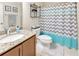 Updated bathroom with decorative shower curtain, granite counters, and updated fixtures at 4703 Somerset Hill Ln, Riverview, FL 33578