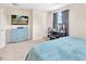 Bright bedroom with plush carpet, blue dresser, and TV; well-lit by natural light at 4703 Somerset Hill Ln, Riverview, FL 33578