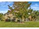 Charming home featuring a spacious green lawn and a beautiful, mature tree in the front yard at 4703 Somerset Hill Ln, Riverview, FL 33578