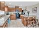 Well-lit kitchen features granite countertops, stainless steel appliances, and a stylish kitchen island with seating at 4703 Somerset Hill Ln, Riverview, FL 33578