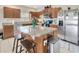 Open kitchen with granite counters, stainless appliances, a center island with seating, and ample cabinet space at 4703 Somerset Hill Ln, Riverview, FL 33578