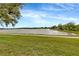 Scenic view of the lake, framed by lush green grass and trees at 4703 Somerset Hill Ln, Riverview, FL 33578