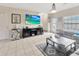 Comfortable living room features tiled floors, a large TV, and ample space for relaxation and entertainment at 4703 Somerset Hill Ln, Riverview, FL 33578