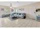 Inviting living room with neutral tones, tiled floors, and a comfortable sectional sofa, great for relaxation at 4703 Somerset Hill Ln, Riverview, FL 33578