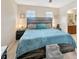 A beautifully furnished main bedroom with a large bed and windows for plenty of light at 4703 Somerset Hill Ln, Riverview, FL 33578