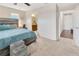 A nicely-decorated main bedroom with a large bed and ensuite bath entry at 4703 Somerset Hill Ln, Riverview, FL 33578