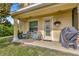 Cozy outdoor patio featuring comfortable seating, a grill, and a hanging flower basket at 4703 Somerset Hill Ln, Riverview, FL 33578