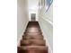 A straight view up the staircase, which features dark wood steps and a white railing at 4703 Somerset Hill Ln, Riverview, FL 33578
